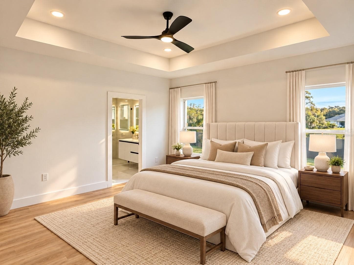 Virtually staged primary bedroom with a tray ceiling and ceiling fan. - 3126 BELLEVILLE TER, NORTH PORT