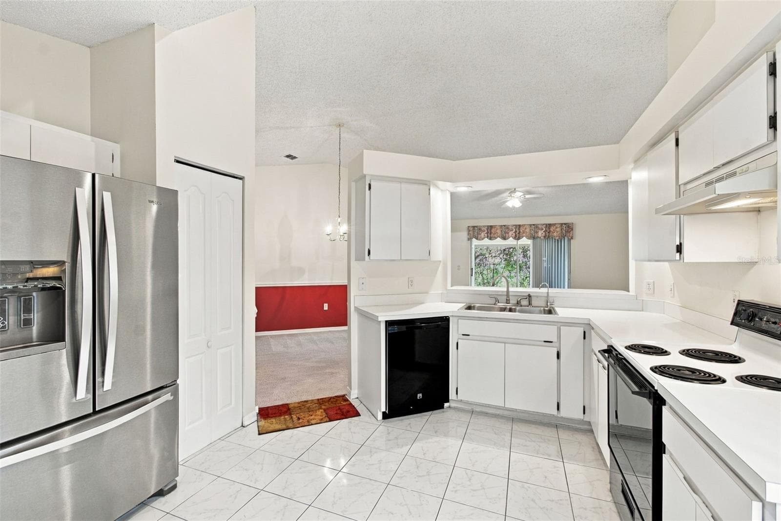 Modern kitchen featuring an open-concept layout with a view of the living area. - 610 LAKEMONT DR, BRANDON