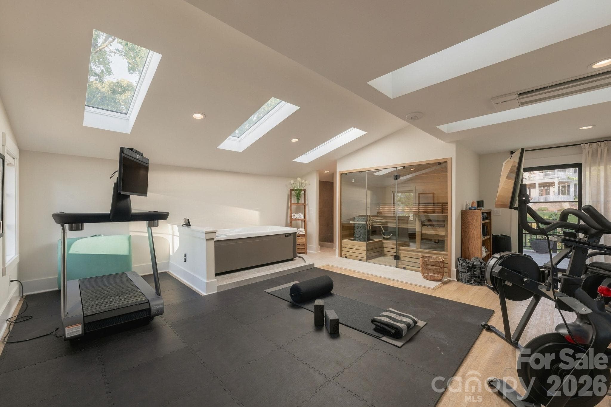 Upper level flex space used as a gym and wellness area, includes tiled shower and cold plunge. - 298 Marietta Road, Mooresville