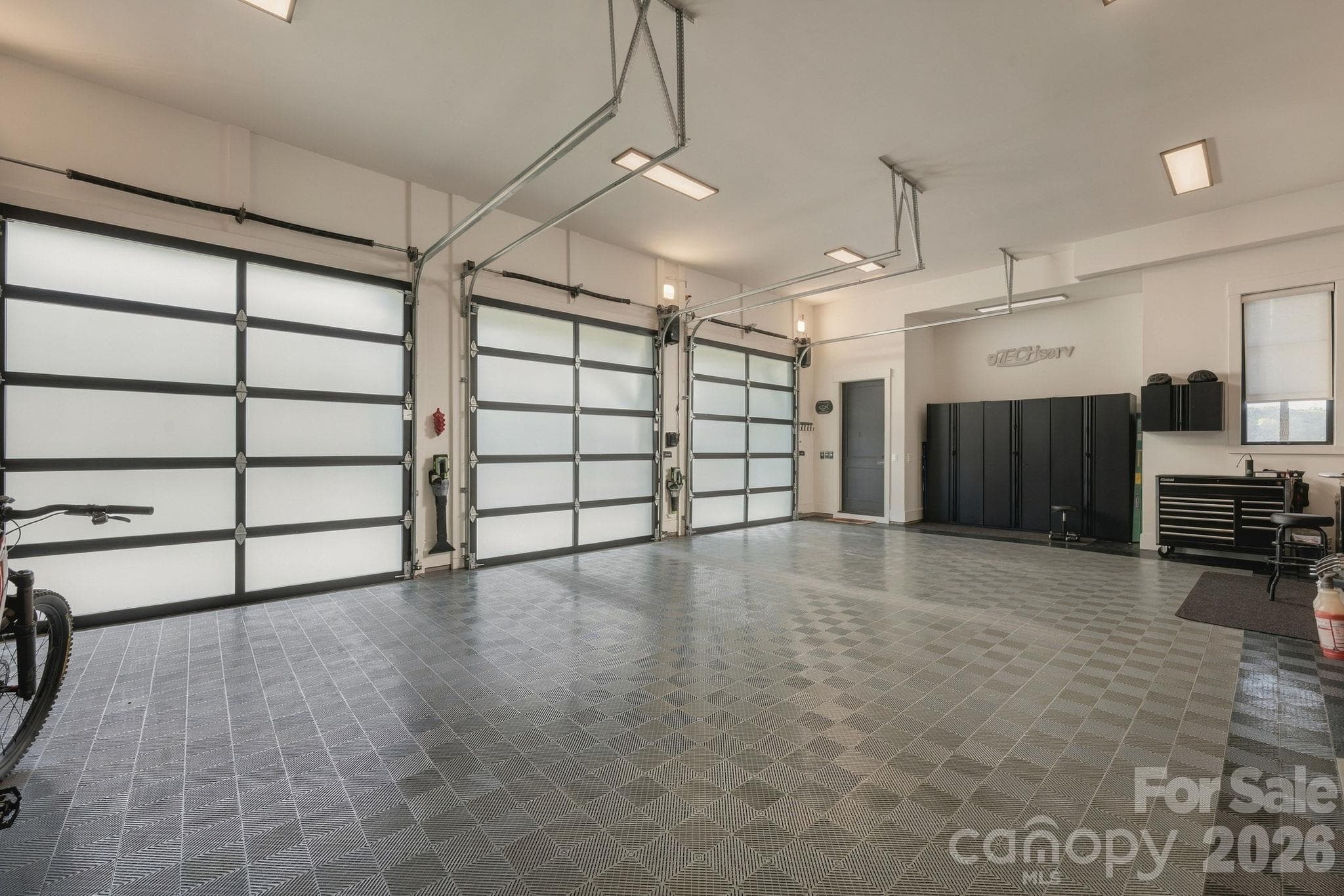 Immaculate garage with Swiss track flooring, piped in water access for car washing - 298 Marietta Road, Mooresville