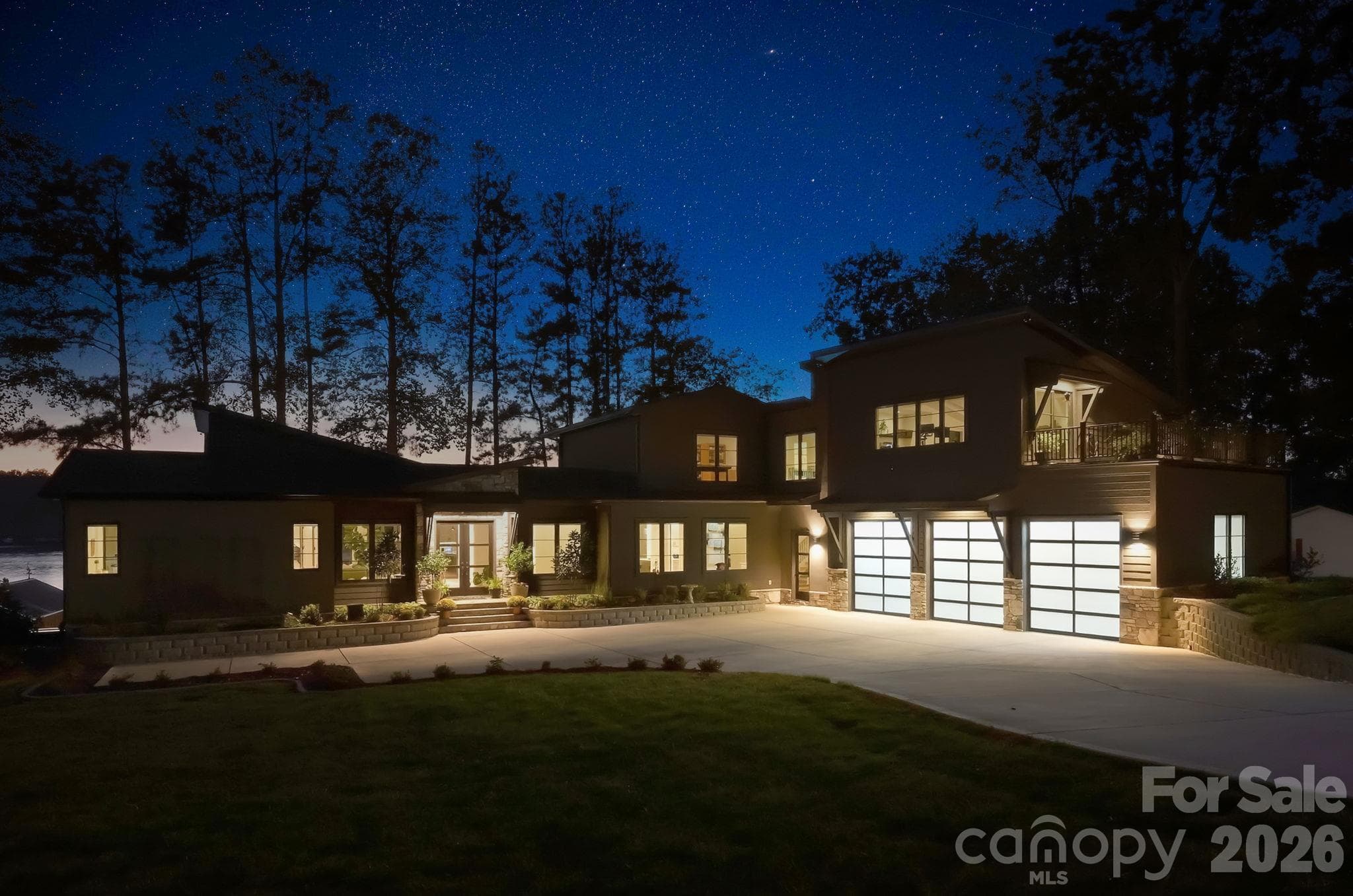 Front exterior at night.  Gorgeous lighting shows off the architectural lines of the property - 298 Marietta Road, Mooresville