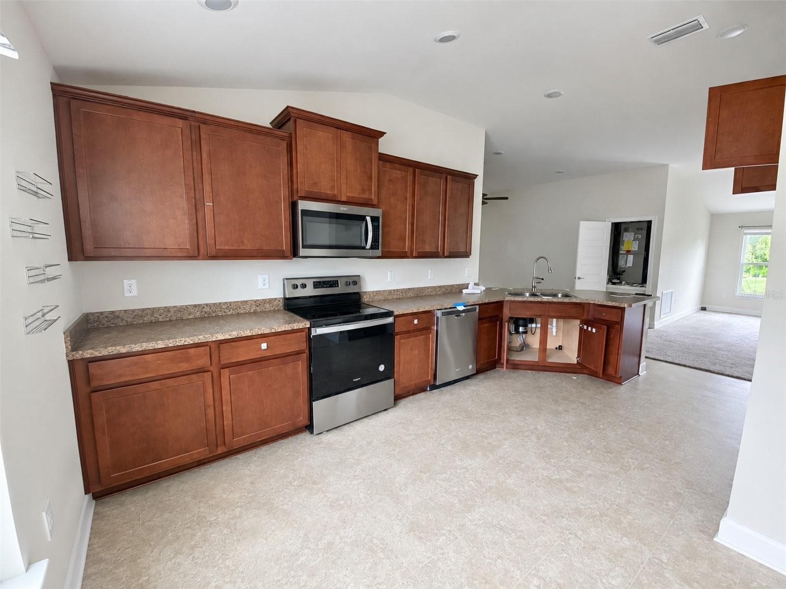 View of Kitchen Cabinets and Peninsula. - 2091 PECOS DR, POINCIANA