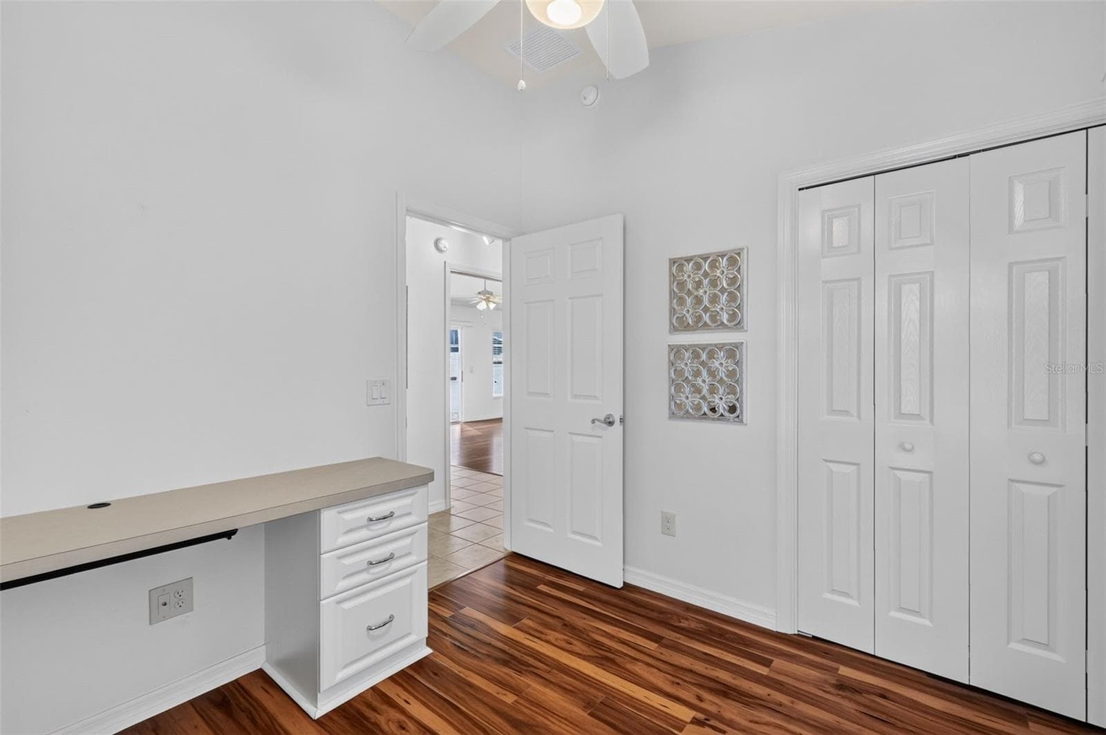Second Bedroom with Murphy Bed, Custom Cabinetry, and Built-In Desk - 3056 EASTWOOD TER, THE VILLAGES