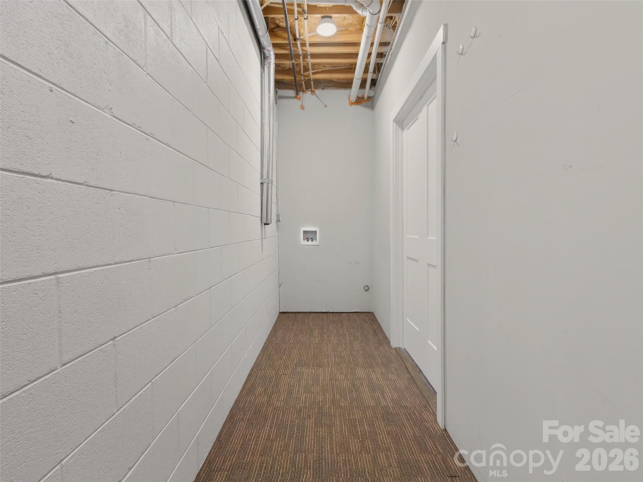 Lower Level Laundry Room with tankless hot water heater. - 133 Asher Lane, Etowah