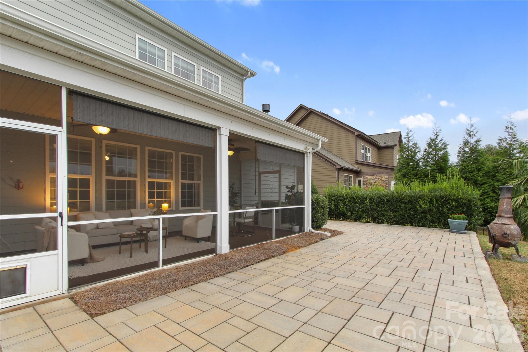 Screened in patio room overlooking back patio - 11926 Grey Partridge Drive, Charlotte