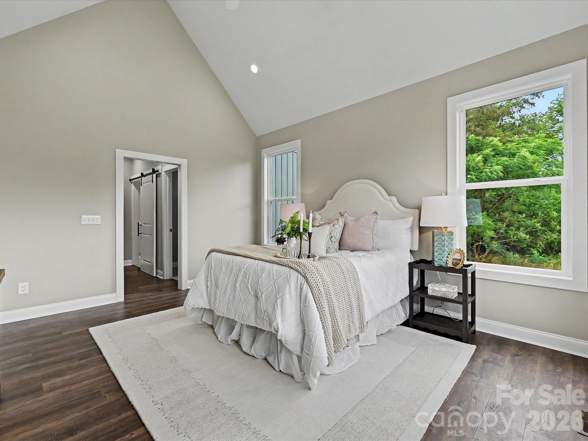 Spacious primary suite features soaring vaulted ceilings, abundant natural light & peaceful views of the private back yard. - 159 Lone Pine Road, Statesville