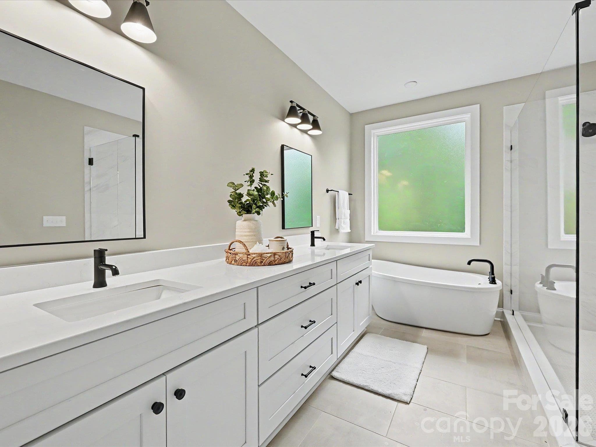Luxurious primary bath offers a dual sink vanity, oversized walk in tile shower & relaxing freestanding soaking tub. - 159 Lone Pine Road, Statesville