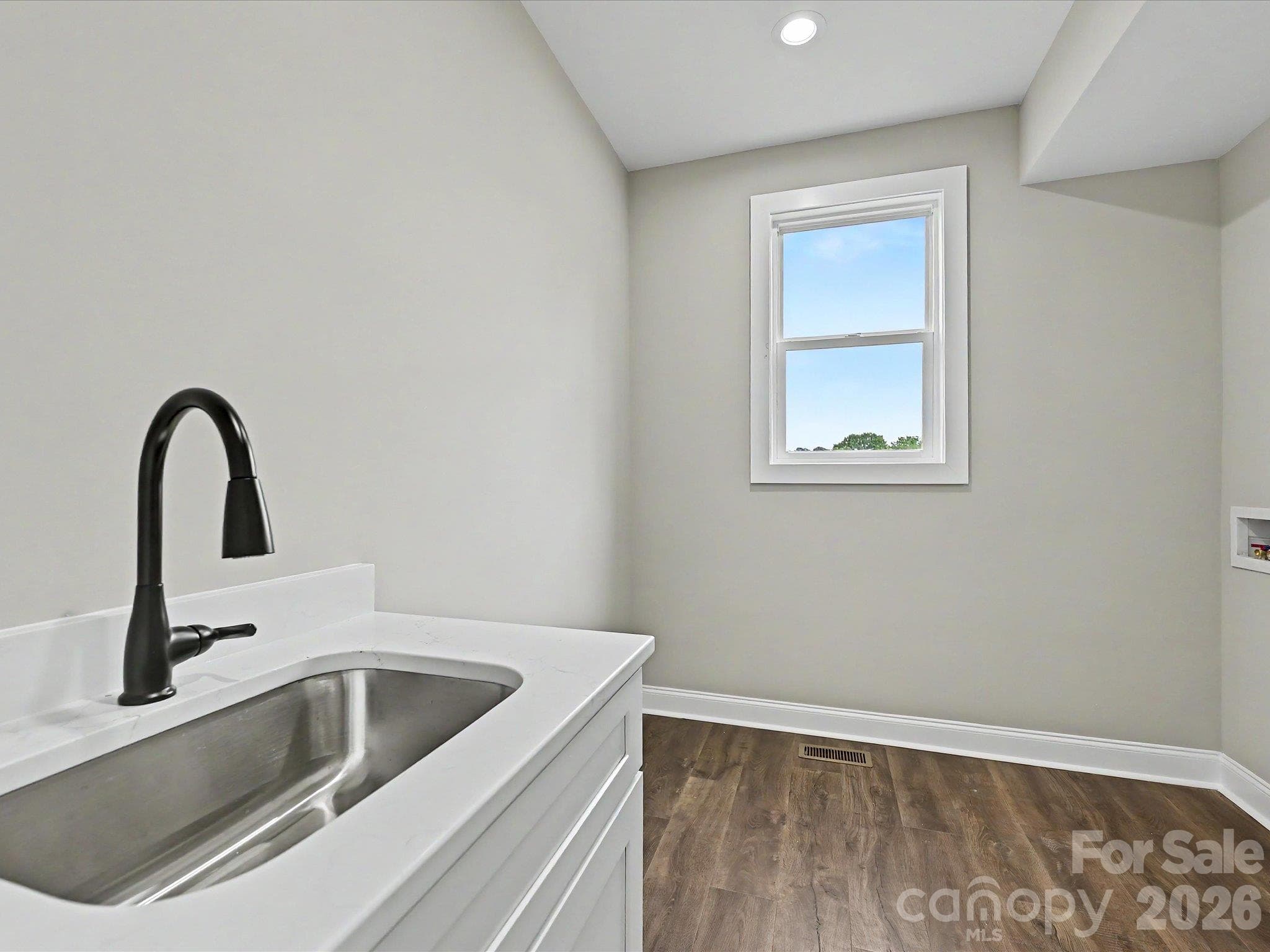 Functional & stylish laundry room offers added convenience with a utility sink, durable flooring & plenty of space for storage & organization. - 159 Lone Pine Road, Statesville