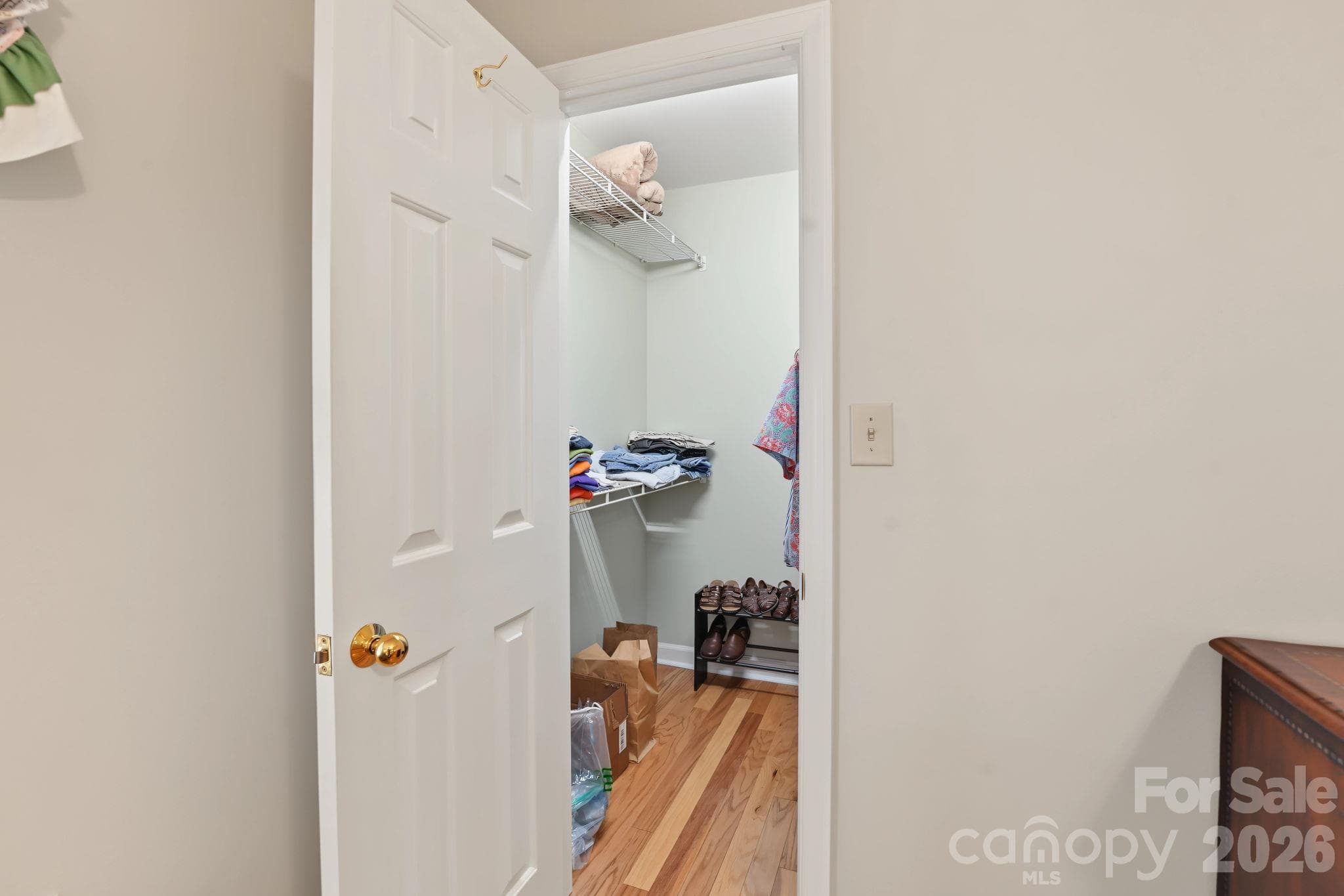 Walk in closet located in Primary - notice the wood flooring - 420 English Ivy Court, Fort Mill