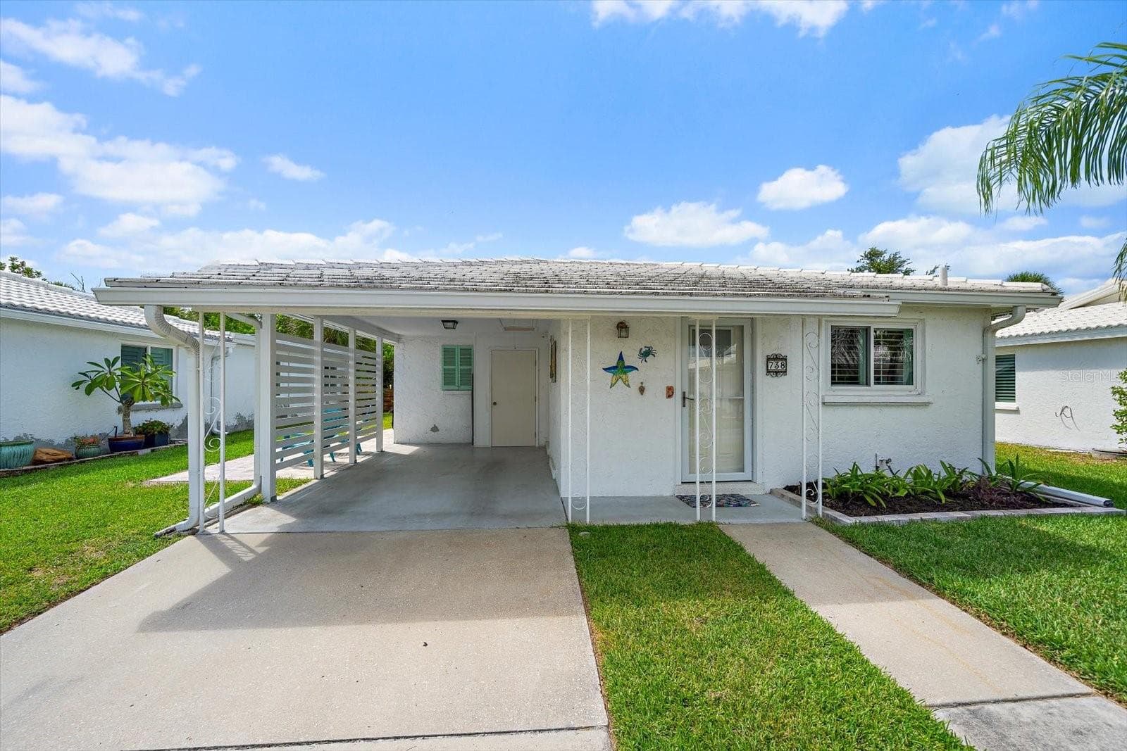 Exterior front view of unit and carport - 738 SPANISH DR S #98, LONGBOAT KEY