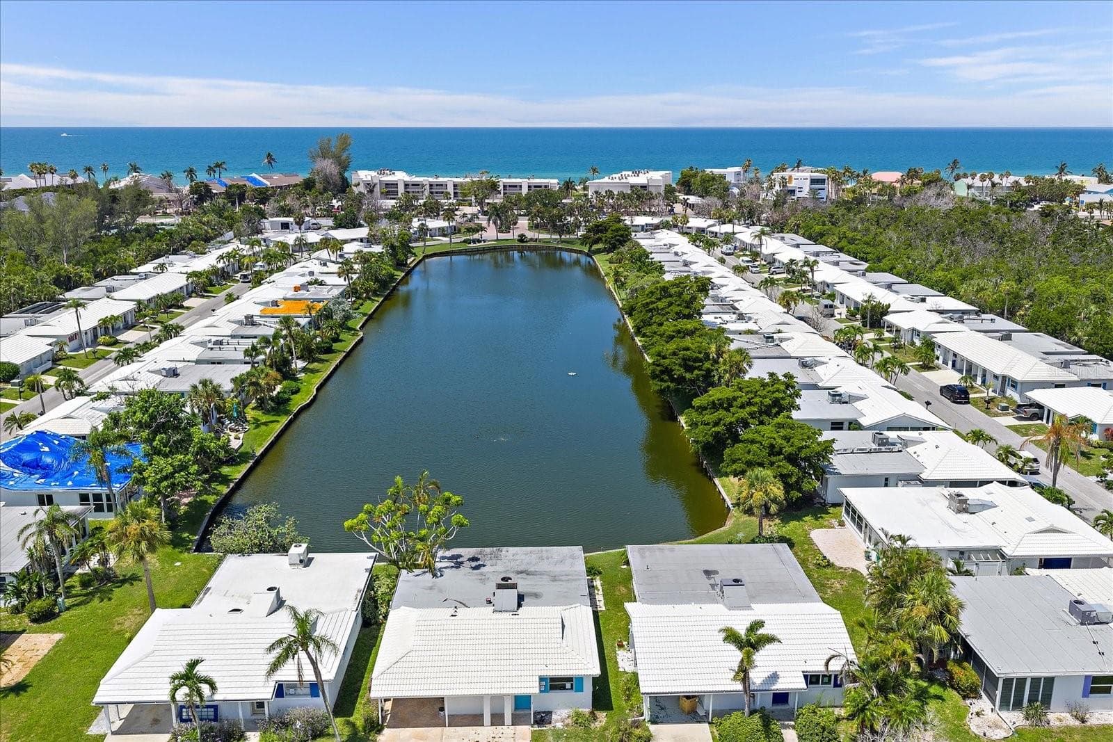 Aerial View Community Lake with Deeded Beach Acess in background - 738 SPANISH DR S #98, LONGBOAT KEY