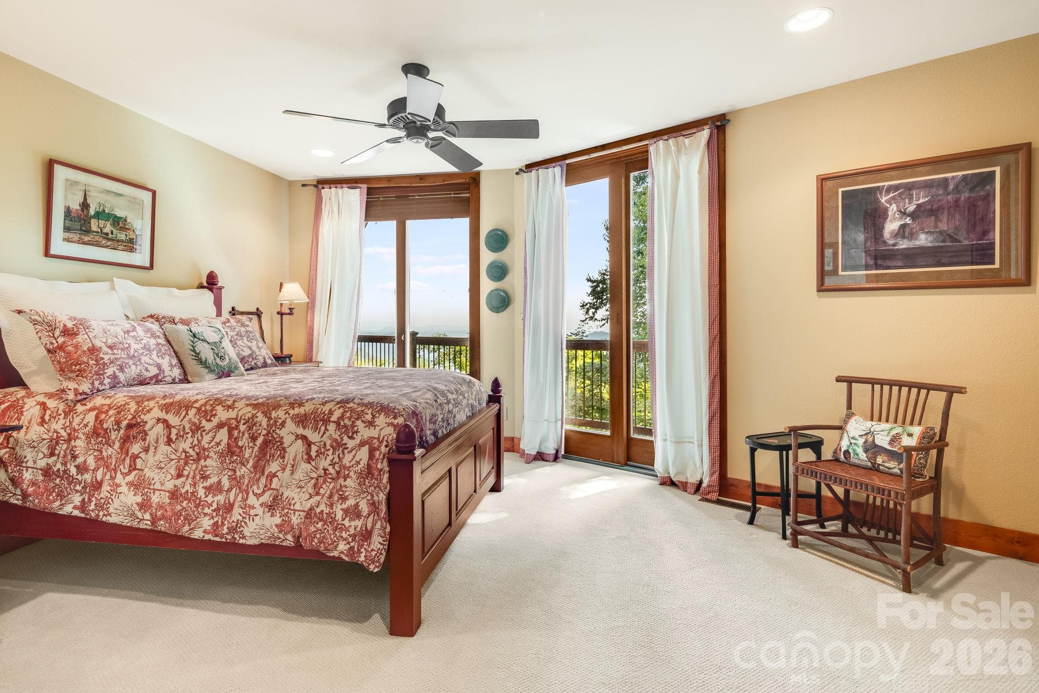 Lower level guest bedroom with doors leading out onto the deck. - 179 Cherry Knob Drive, Mars Hill