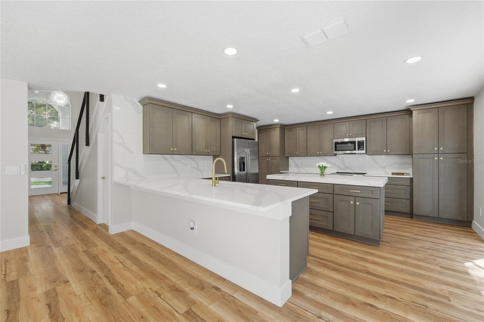 This chef’s dream offers elegant stone countertops, a deep undermount sink, and ample storage - 13044 BELLERIVE LN, ORLANDO