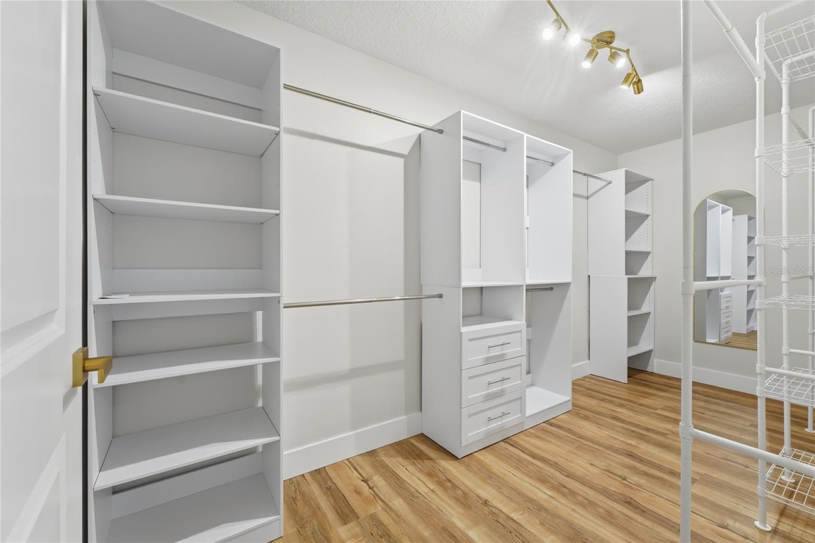 Master Closet with an organized wardrobe set up - 13044 BELLERIVE LN, ORLANDO