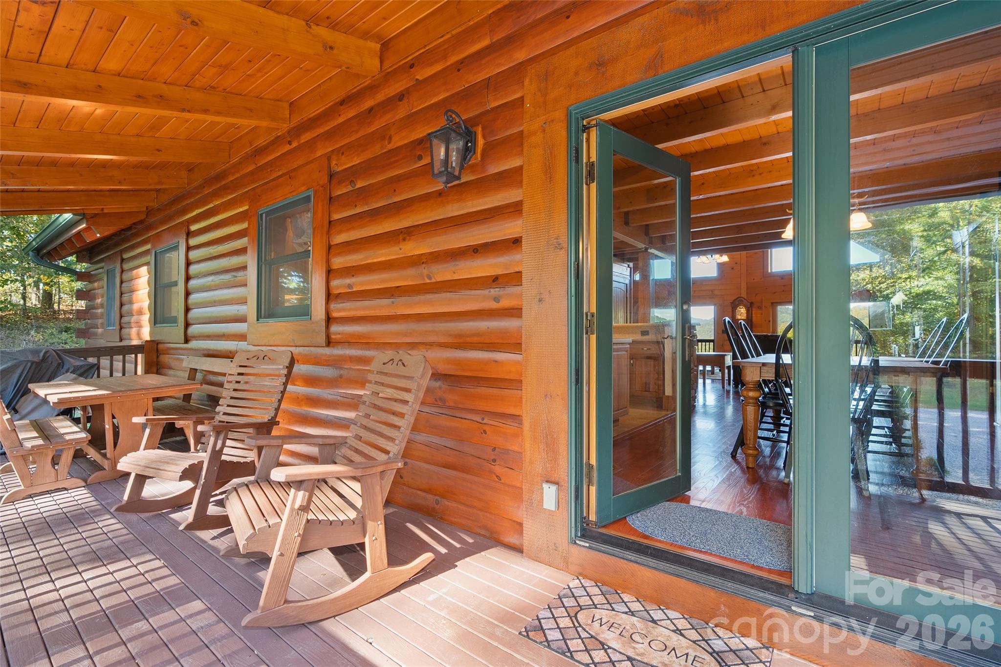 Covered deck offers a peaceful setting to enjoy the outdoors. - 124 Borges Lane, Waynesville