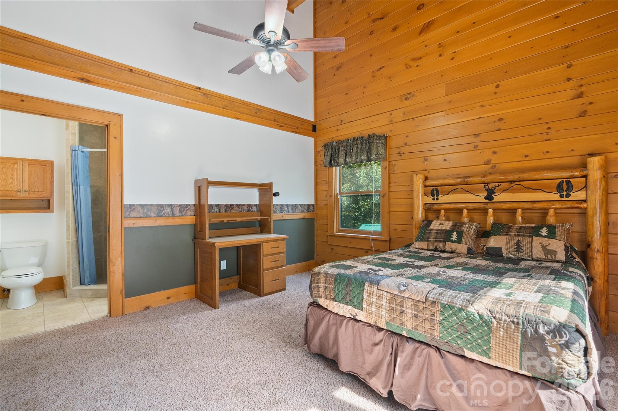 Another generously sized bedroom with attractive wood accents and natural light. - 124 Borges Lane, Waynesville