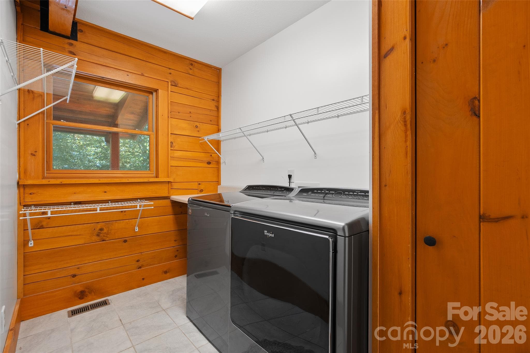 Convenient laundry area with built-in cabinetry and utility sink. - 124 Borges Lane, Waynesville