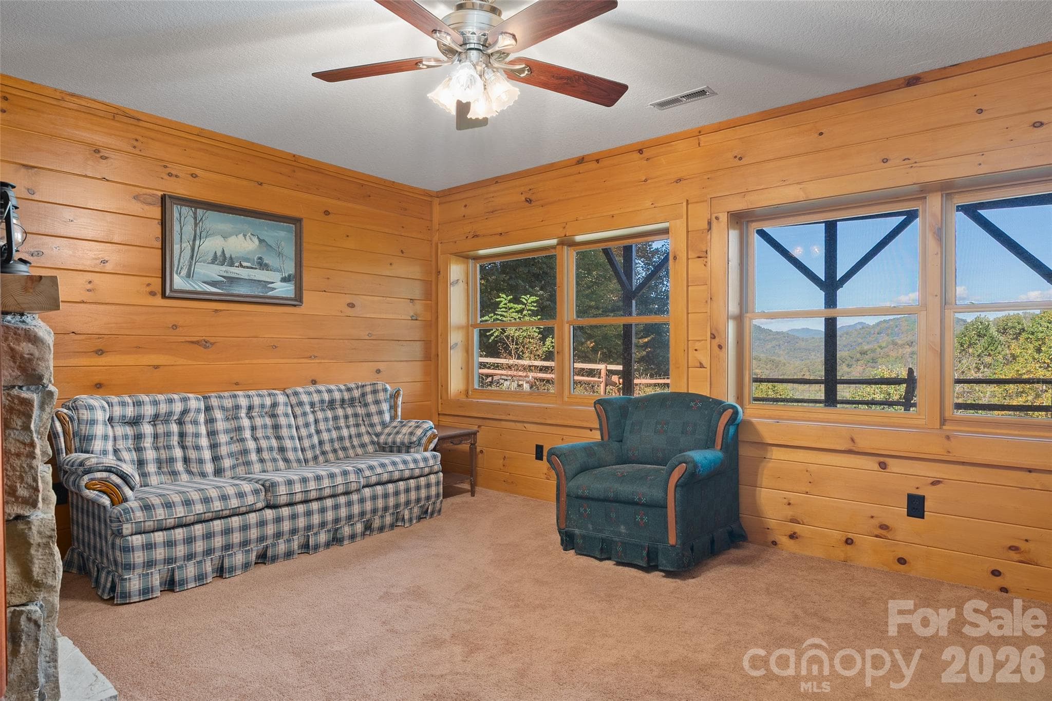Cozy lower-level sitting area/bedroom with windows framing beautiful mountain views. - 124 Borges Lane, Waynesville