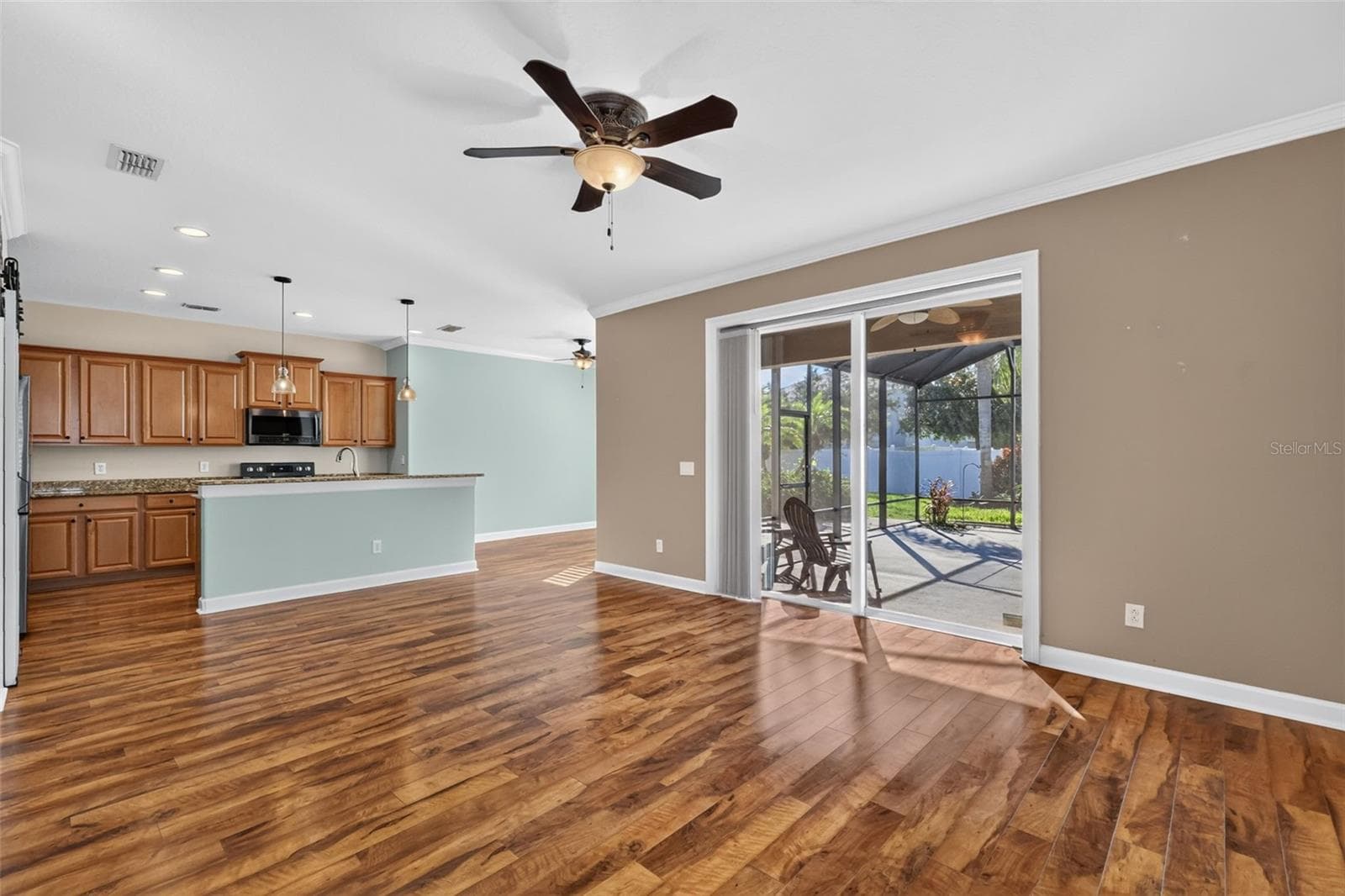 The living room is 11'3"x15'6" with plenty of space to arrange your furniture collection ~ - 4913 ROYCE DR, MOUNT DORA