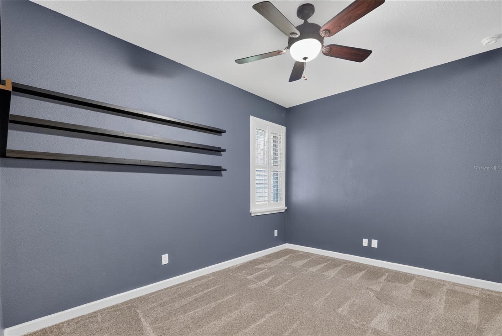 Bedroom 2 is 10'2" x 13' with a wardrobe closet and display shelving ~ - 4913 ROYCE DR, MOUNT DORA