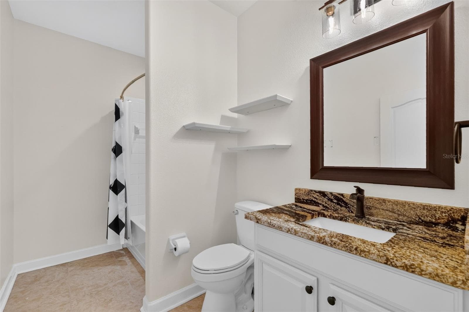 Bath 2 has a tub/shower, shower head with a handheld, and lovely granite counters ~ - 4913 ROYCE DR, MOUNT DORA