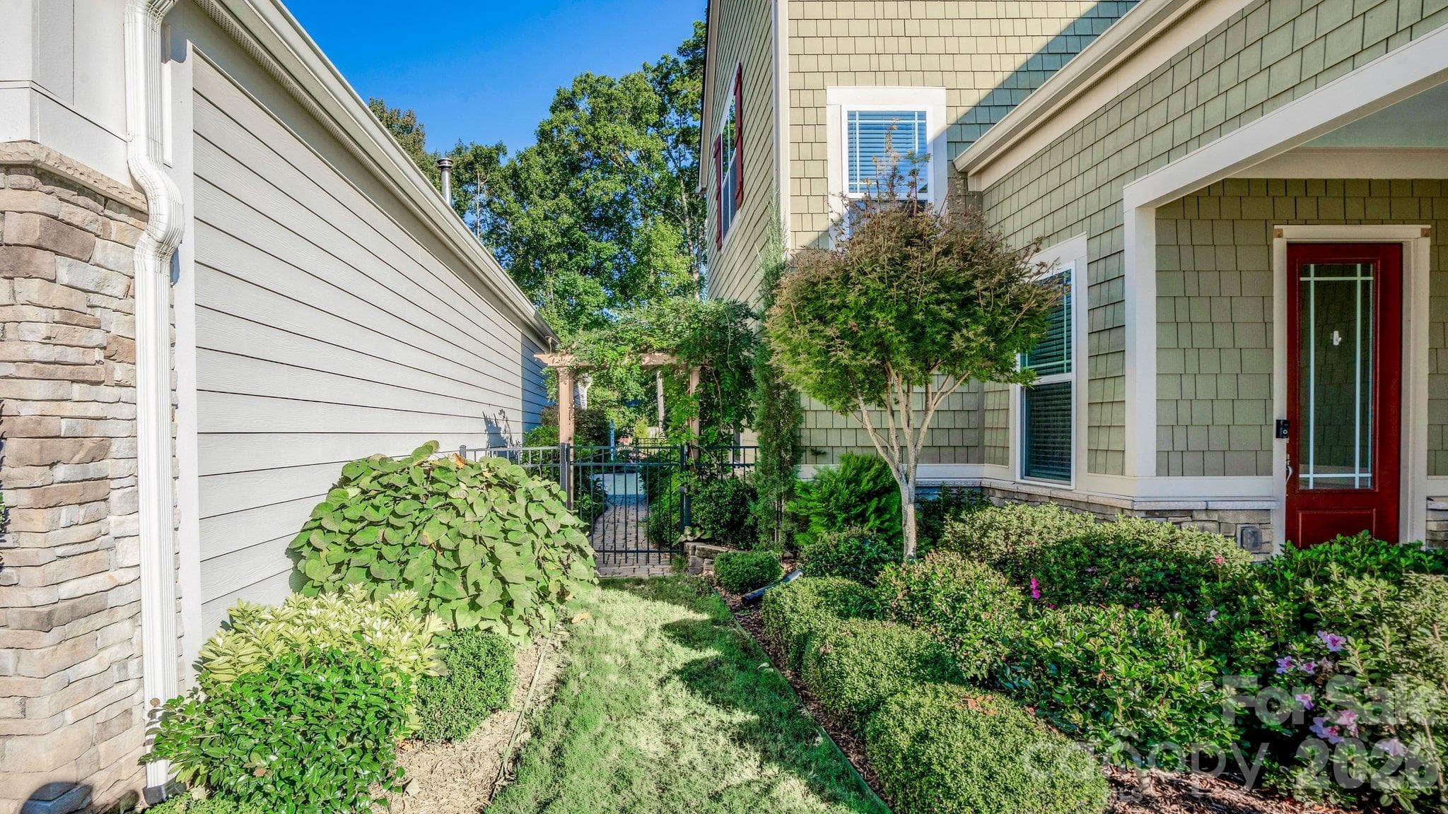 Lush landscaping lines the walkway to the front entry - 2050 Laney Pond Road, Matthews