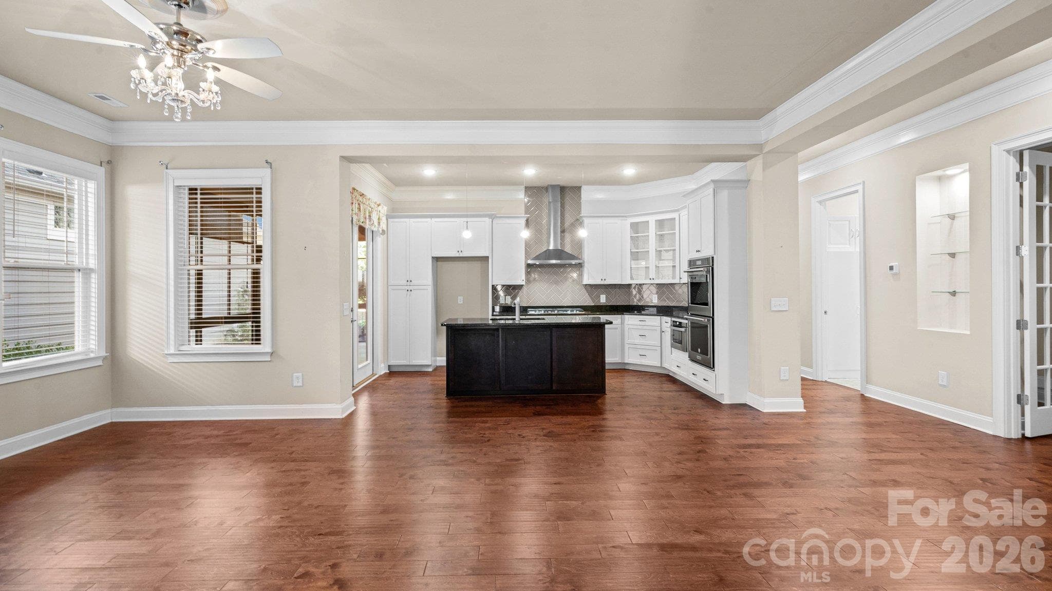 Open-concept living with hardwood floors and crown molding - 2050 Laney Pond Road, Matthews
