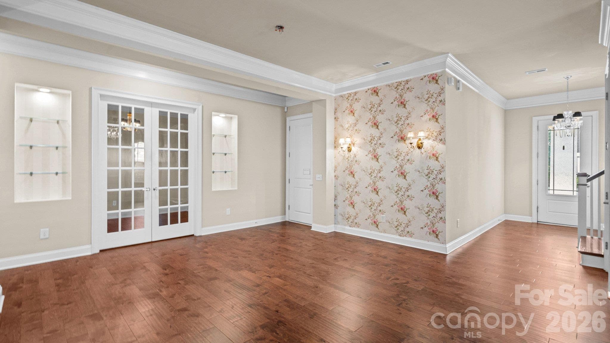 Great room with French doors and designer accent wall - 2050 Laney Pond Road, Matthews