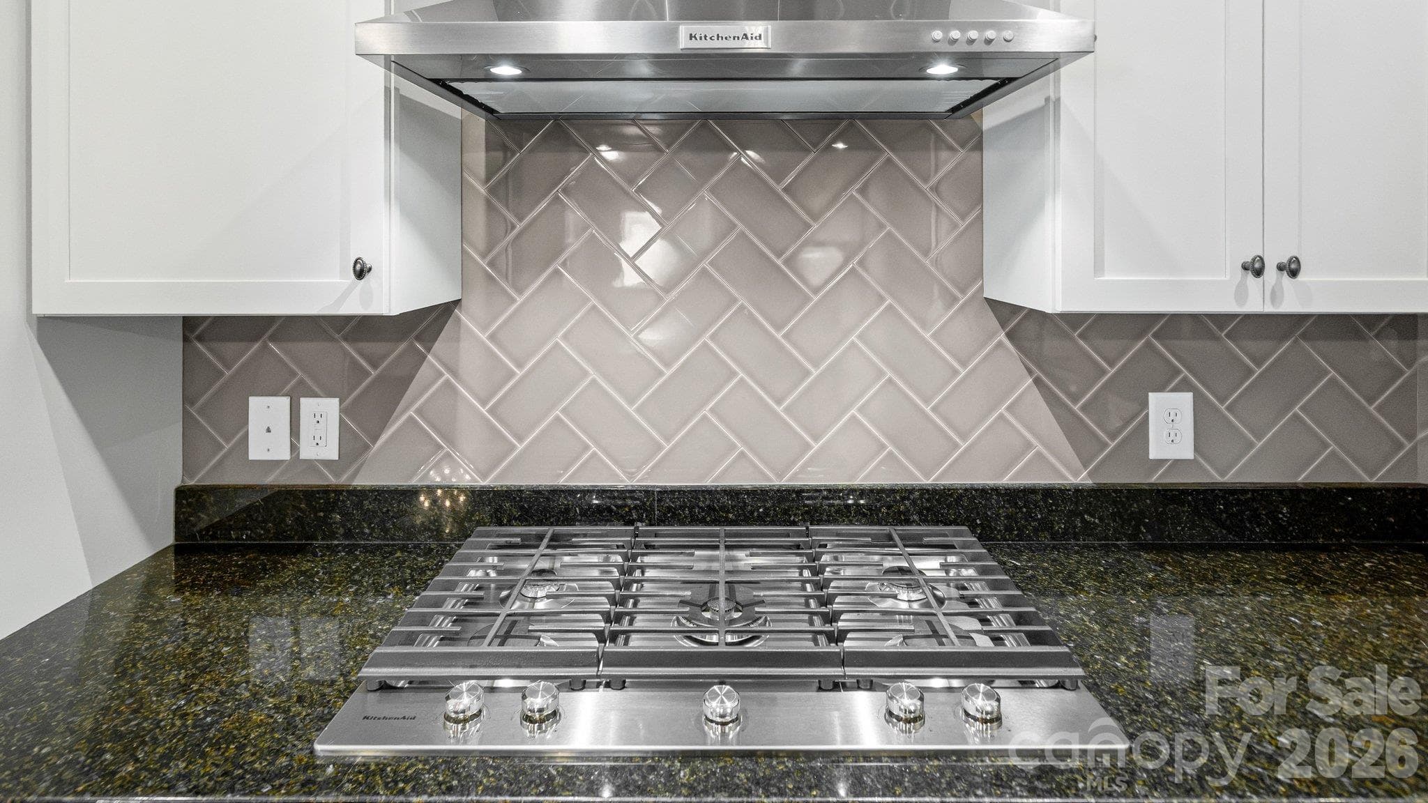 Gas cooktop with stainless hood and tile backsplash - 2050 Laney Pond Road, Matthews