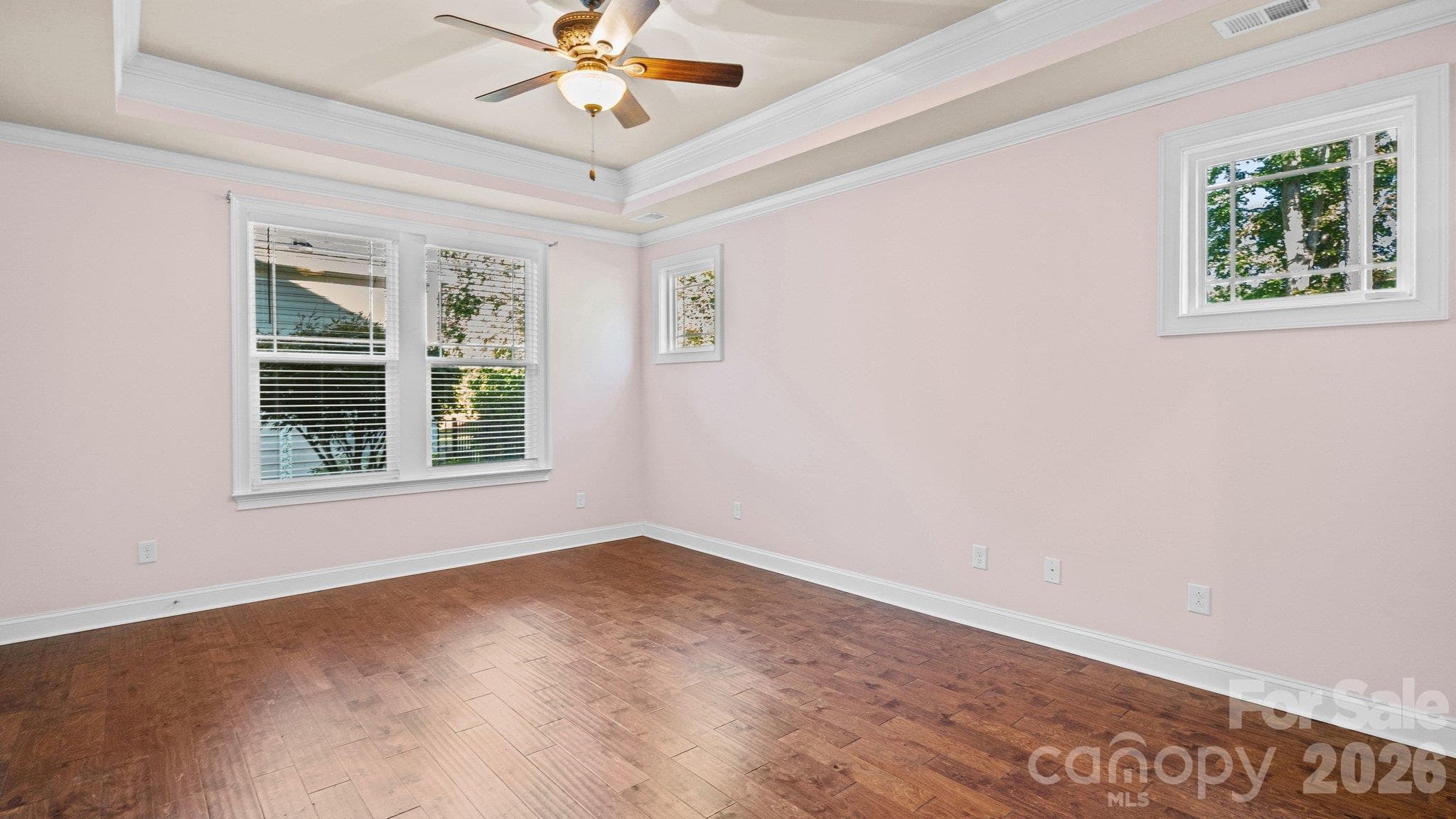 Spacious primary bedroom with ceiling fan and abundant natural light - 2050 Laney Pond Road, Matthews