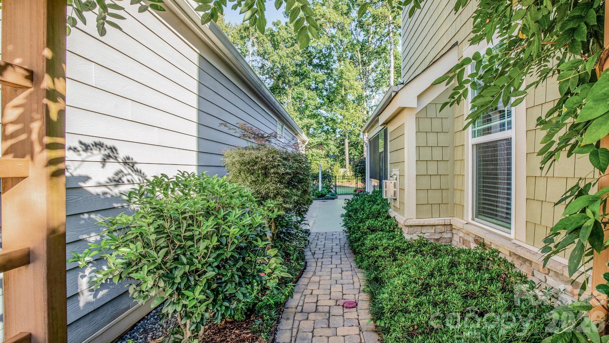 Landscaped side yard with paver walkway - 2050 Laney Pond Road, Matthews