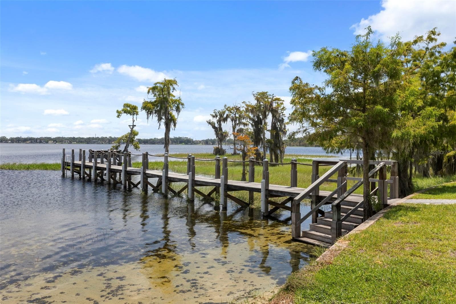 A private dock and boatlift provide access to Lake Sheen and the entire Butler Chain, while a gated community boat ramp is approximately 300 feet away. - 10430 LAKE COTTAGE LN, ORLANDO