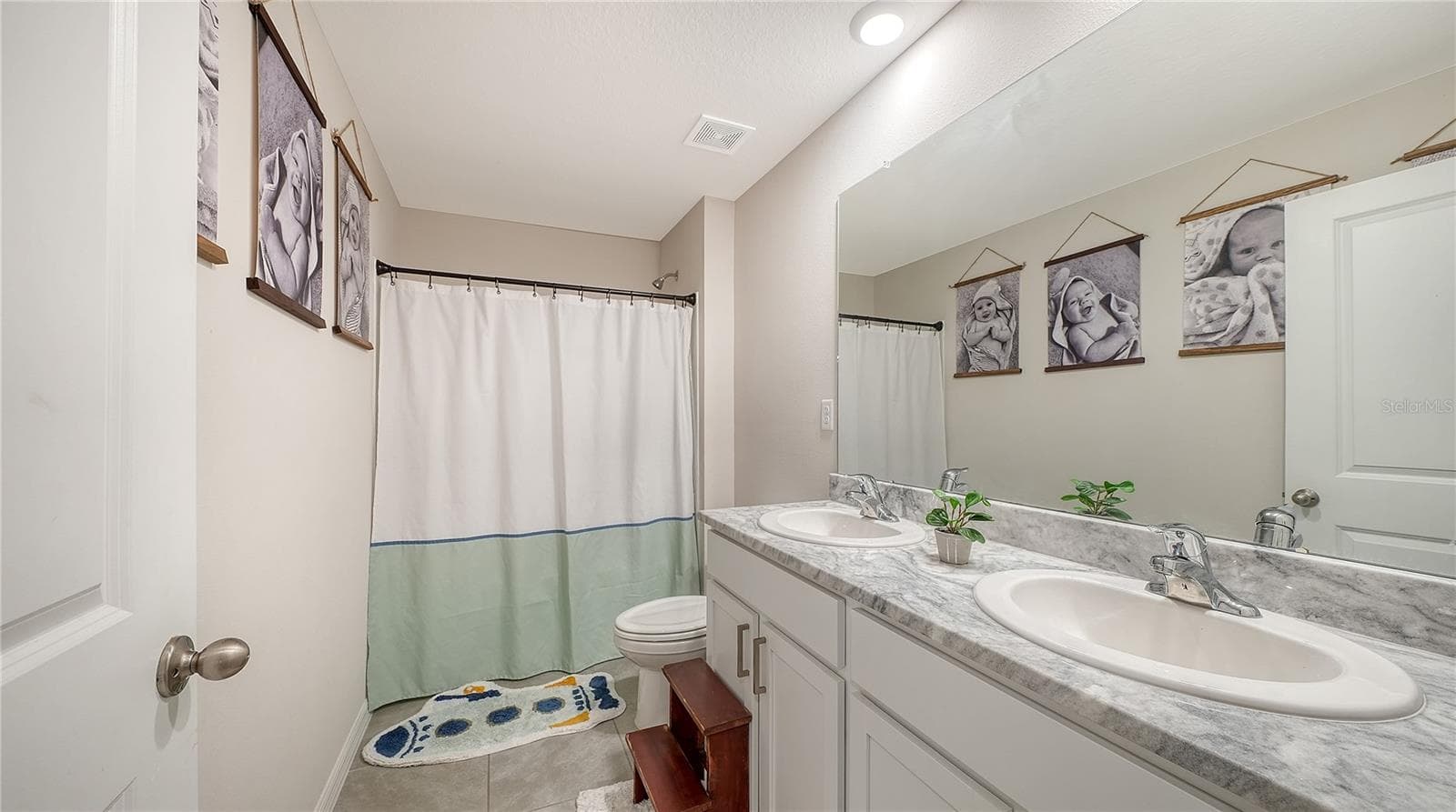 Upstairs full bathroom with dual vanity sinks - 10016 BIG MARSH TER, PARRISH