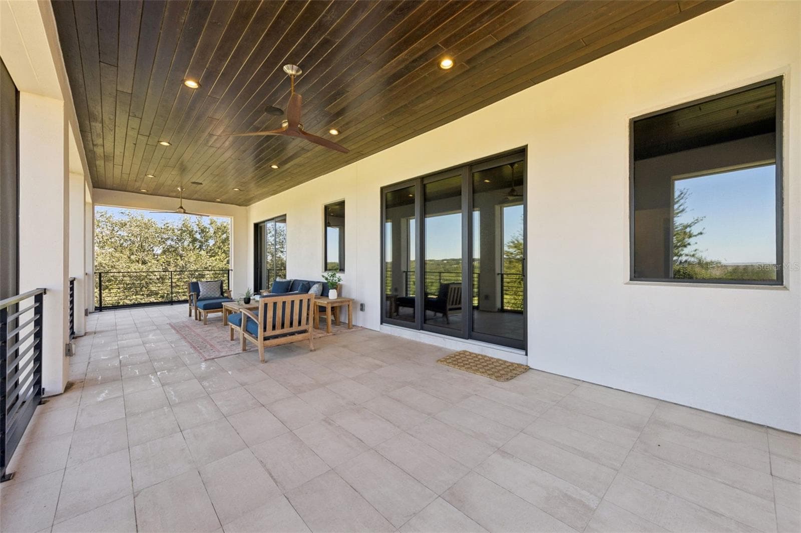 Balcony from primary bedroom, with retractable screens. - 16101 VETTA DR, MONTVERDE