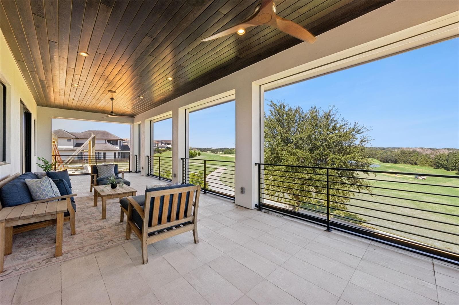 Balcony from primary bedroom, with retractable screens. - 16101 VETTA DR, MONTVERDE