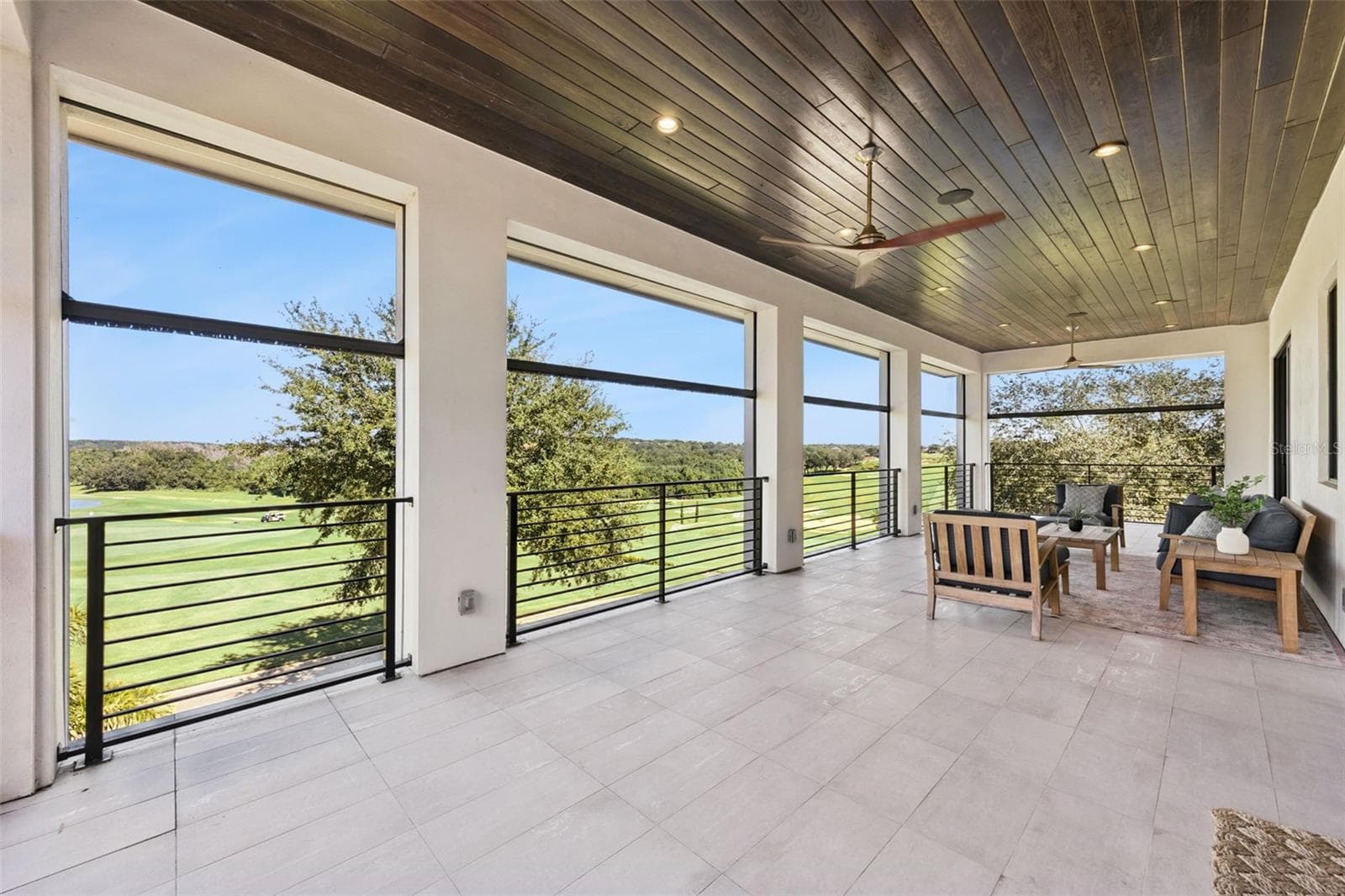 Balcony from primary bedroom, with retractable screens. - 16101 VETTA DR, MONTVERDE