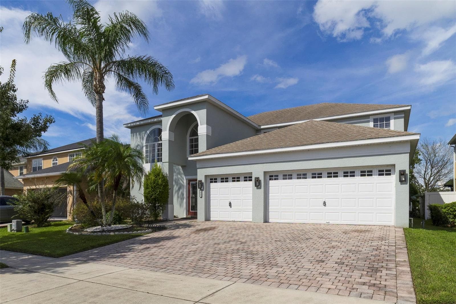 With a SCENIC POND VIEW from the front, attractive landscaping and a brick-paver driveway leading to the THREE-CAR GARAGE, this home makes a wonderful first impression. - 1557 AMARYLLIS CIR, ORLANDO