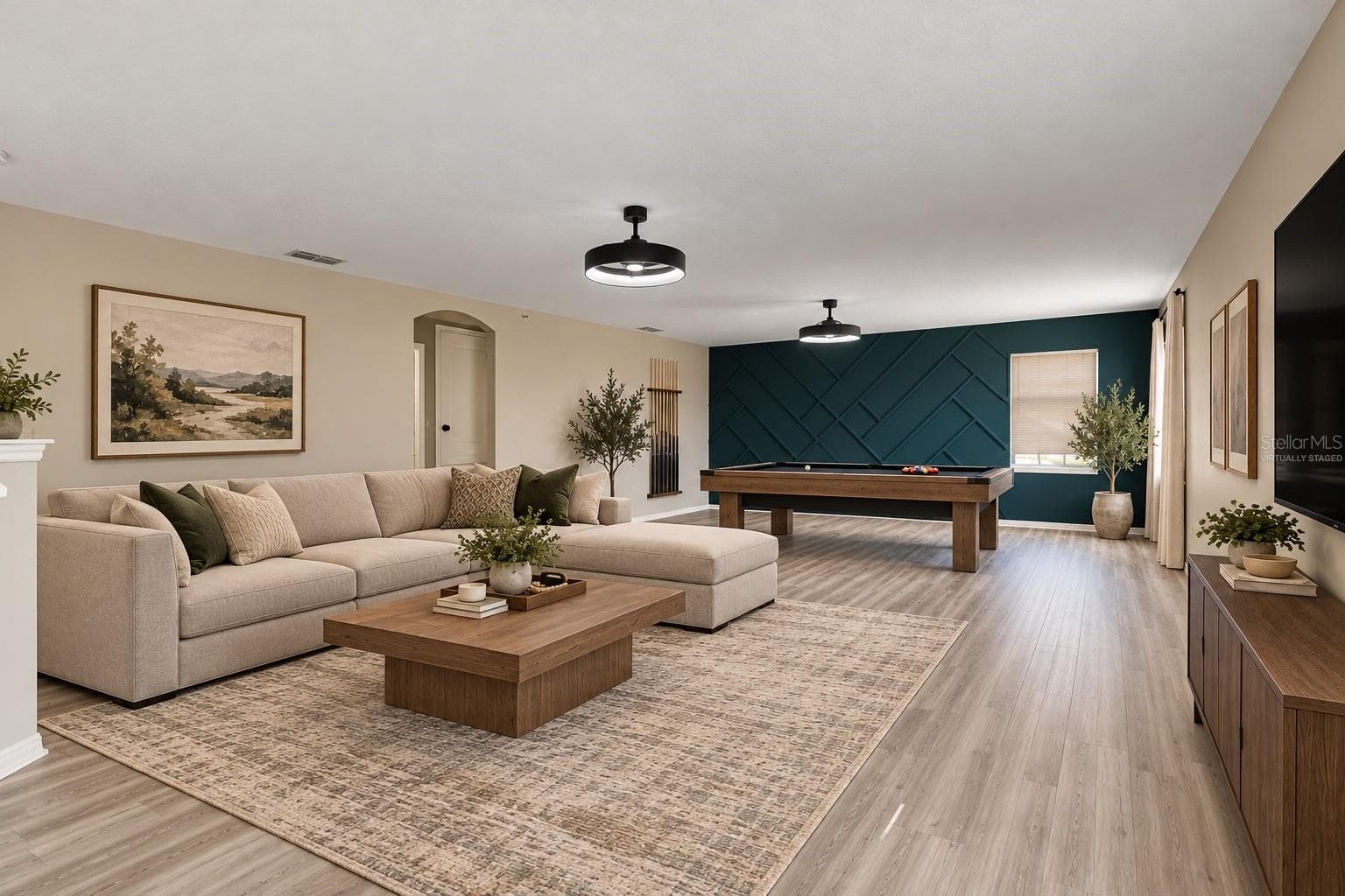 Upstairs, a HUGE LOFT with UPDATED LIGHT/FAN FIXTURES and an accent wall, provides valuable flex space for a media room, game room, home office or additional lounge area. Virtually Staged - 1557 AMARYLLIS CIR, ORLANDO