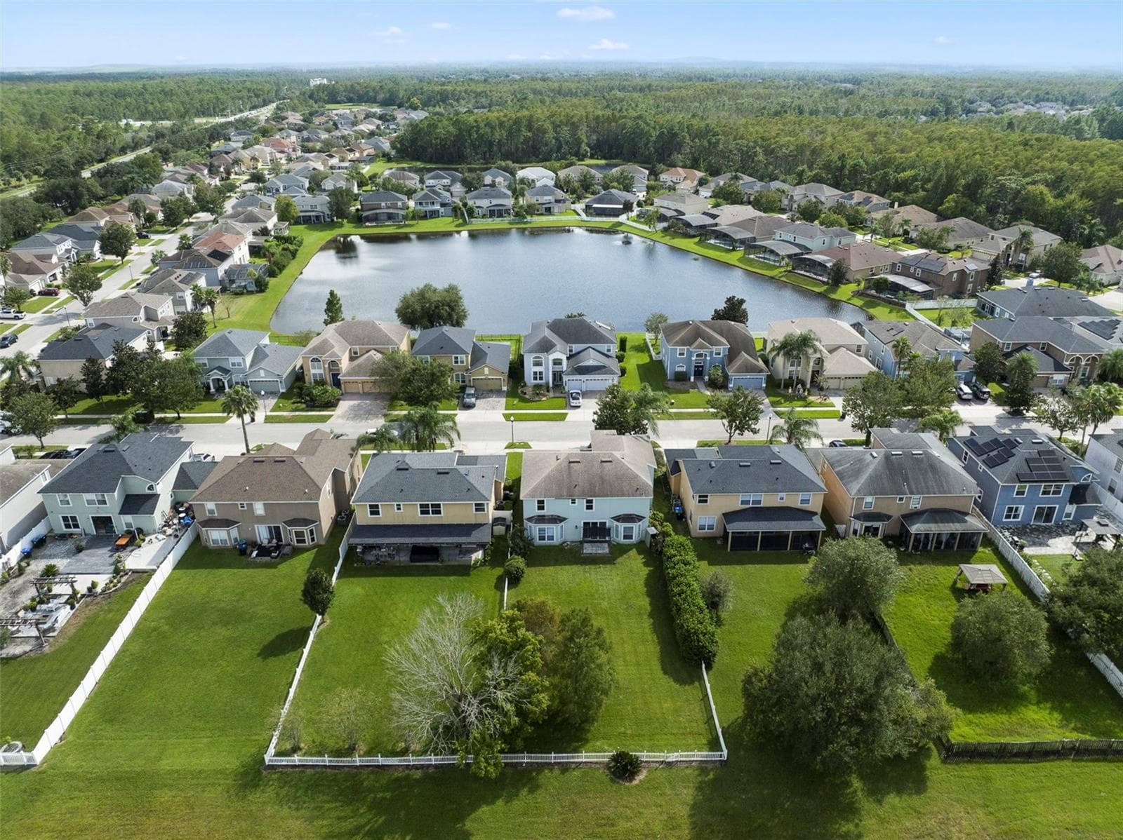 Aerial view of the back of the home and community. - 1557 AMARYLLIS CIR, ORLANDO