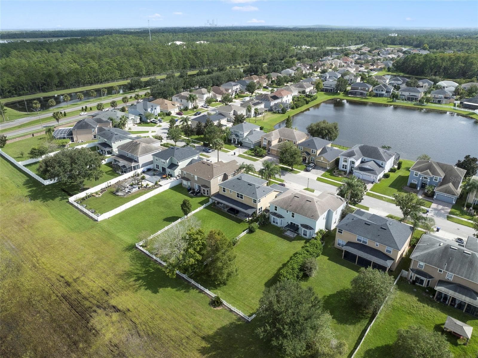 Aerial view of the back of the home and community. - 1557 AMARYLLIS CIR, ORLANDO