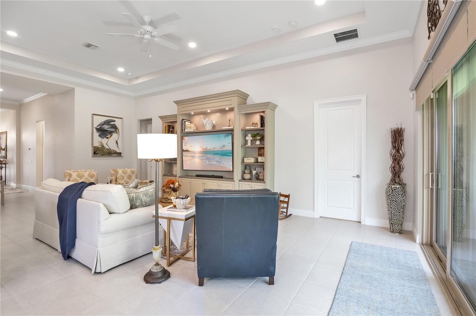 Spacious living area with beautiful finishes and abundant natural light. - 15749 CUTTER SAIL PL, WINTER GARDEN
