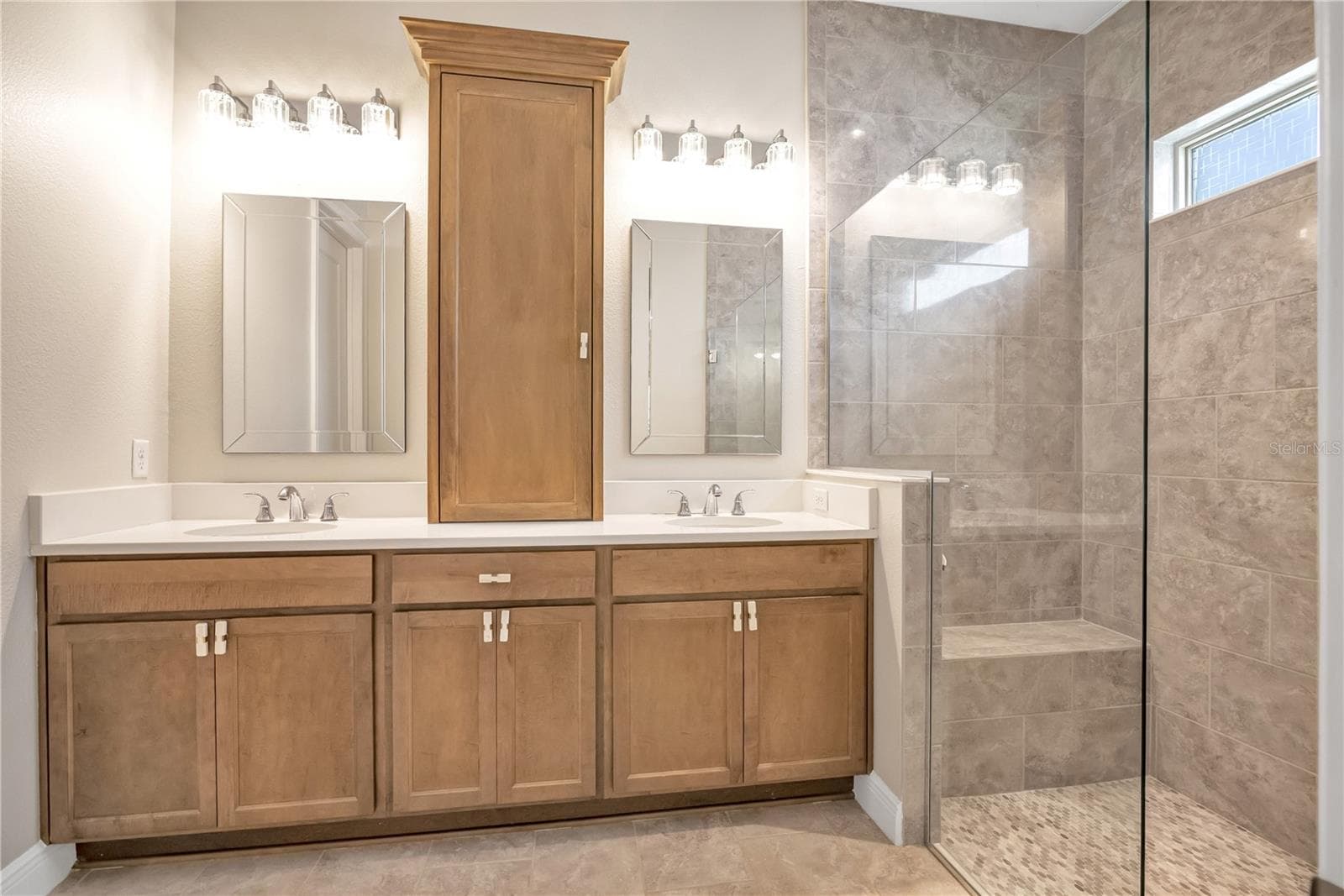 Bright bathroom featuring a contemporary vanity and stylish fixtures. - 15749 CUTTER SAIL PL, WINTER GARDEN