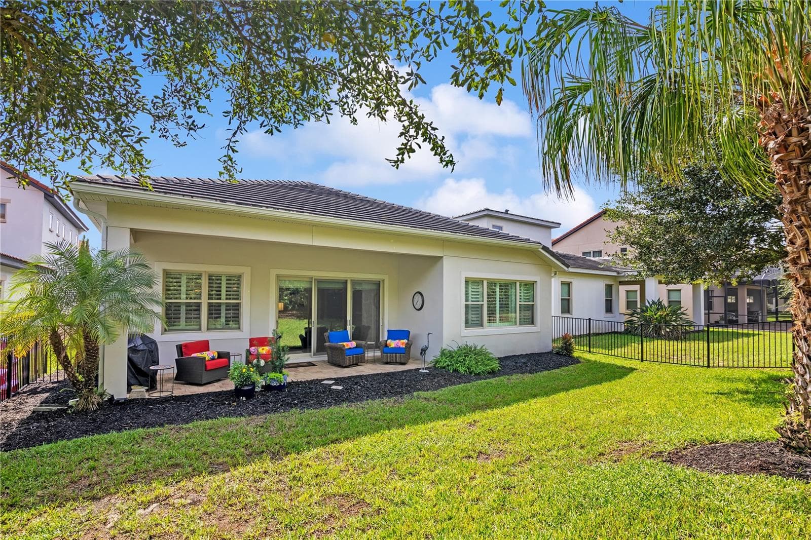 Enjoy Florida living from the covered patio, ideal for outdoor dining and relaxation. - 15749 CUTTER SAIL PL, WINTER GARDEN
