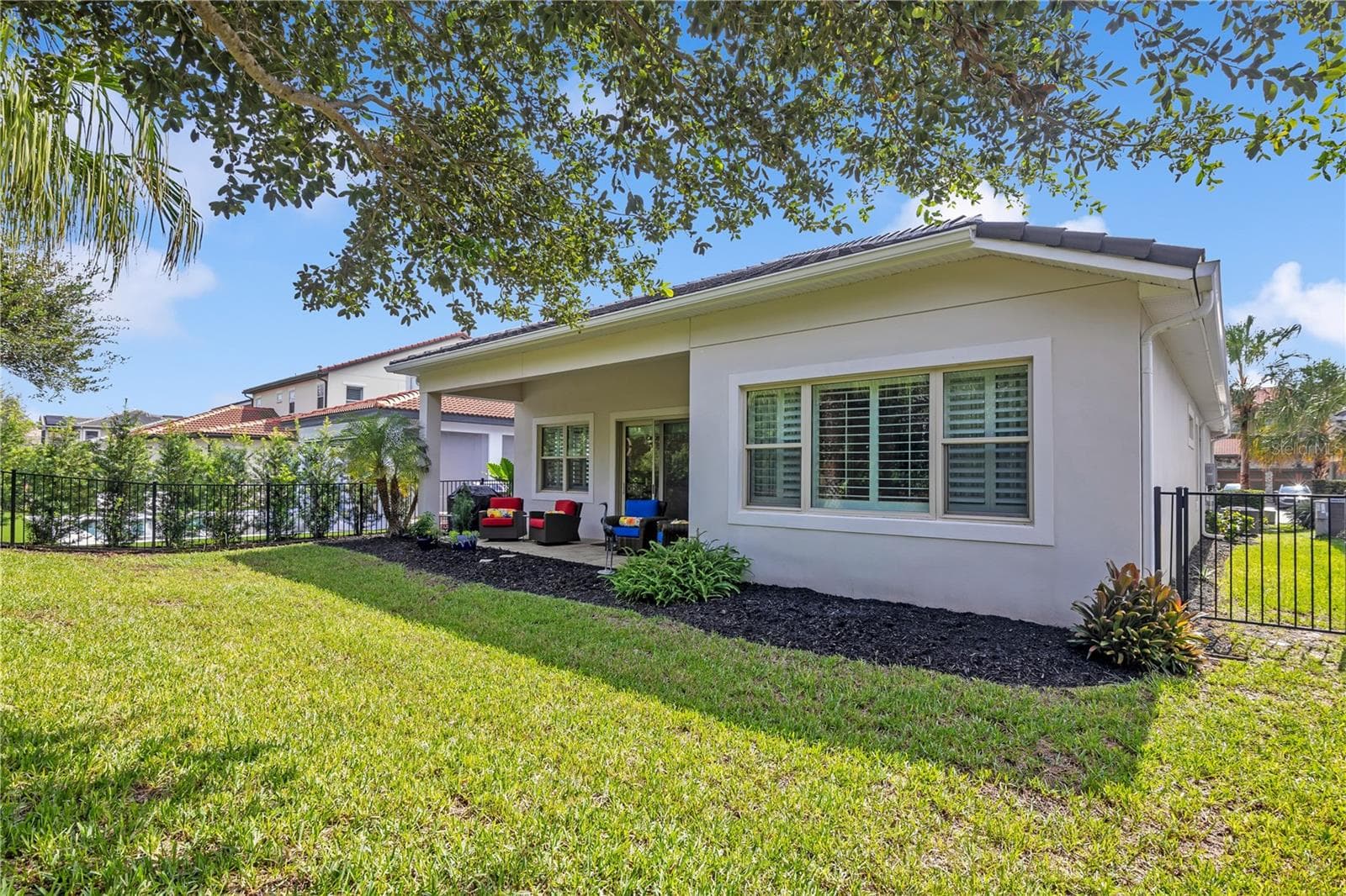 eautifully maintained backyard with lush green lawn, mature landscaping, and attractive fencing. - 15749 CUTTER SAIL PL, WINTER GARDEN