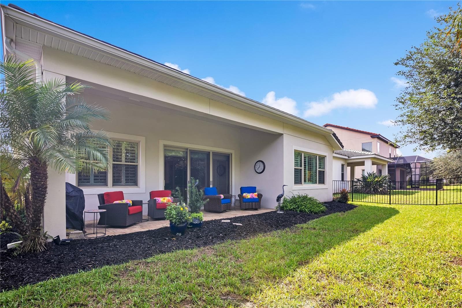 Enjoy Florida living from the covered patio, ideal for outdoor dining and relaxation. - 15749 CUTTER SAIL PL, WINTER GARDEN