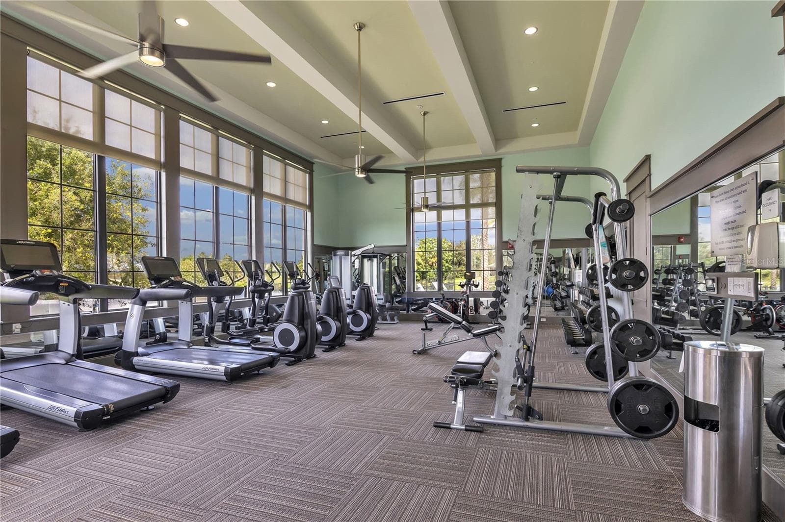 Well-equipped community fitness center with cardio and strength-training equipment. - 15749 CUTTER SAIL PL, WINTER GARDEN