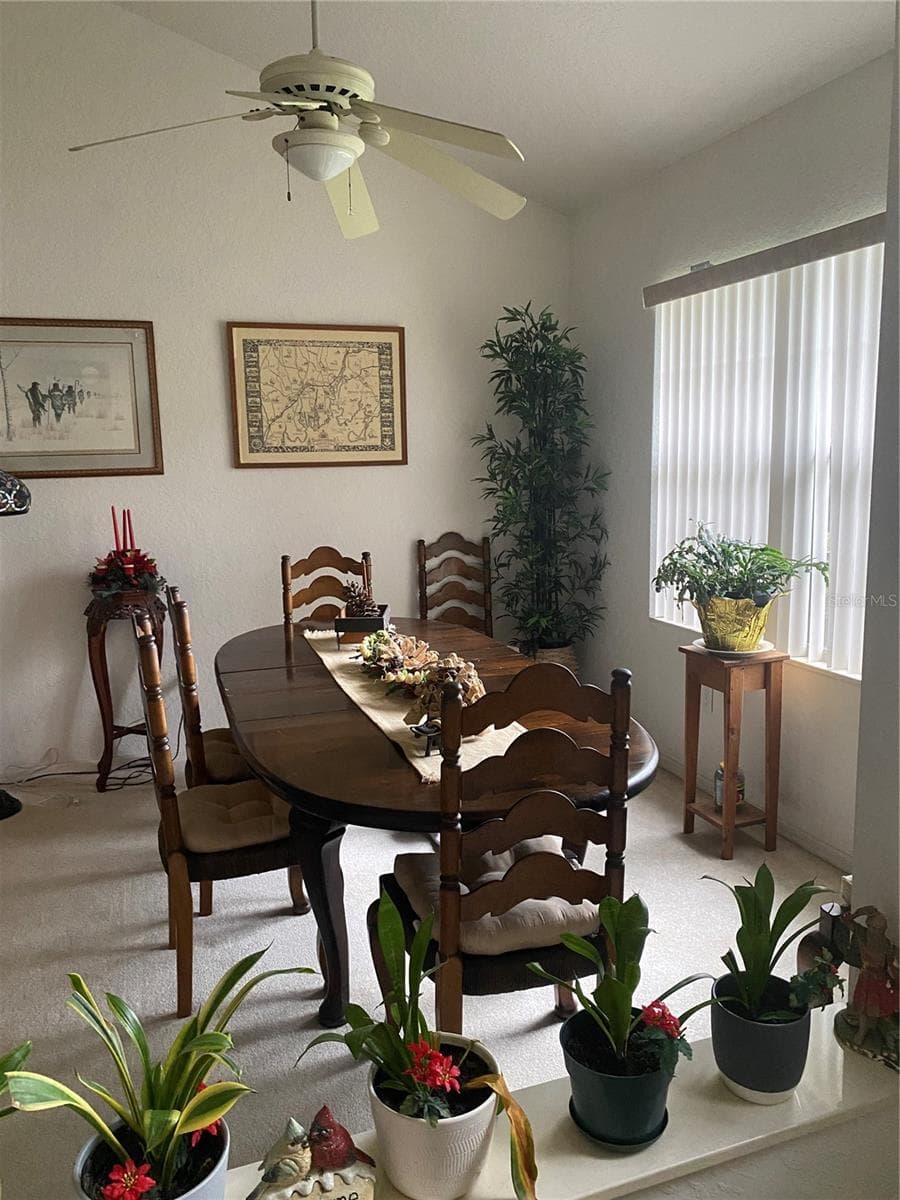 Formal dining room area. Large window, ceiling fan with lights, high ceiling, spacious area. - 11492 SW 82ND COURT RD, OCALA