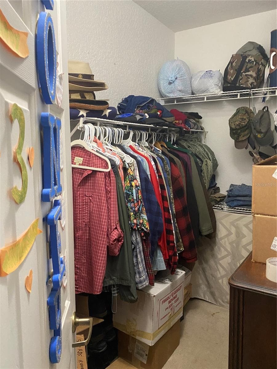 Walk-in closet in the primary bedroom area. - 11492 SW 82ND COURT RD, OCALA
