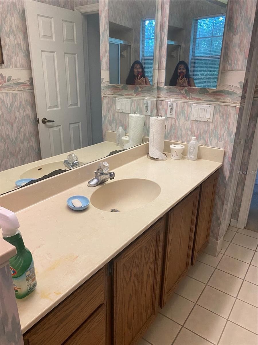 Guest bathroom with vanity and plenty of drawers and cabinet. - 11492 SW 82ND COURT RD, OCALA