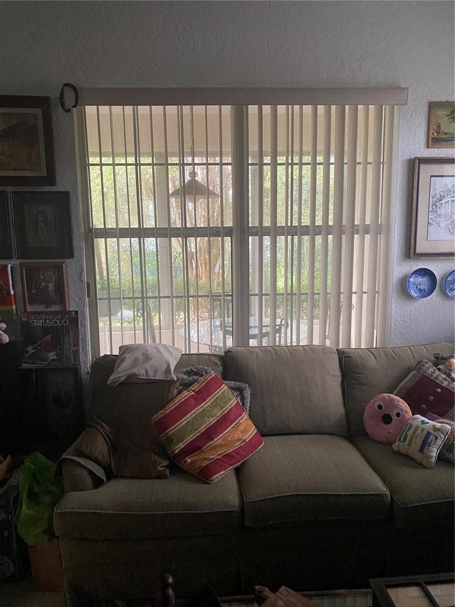 Den area with large window facing the lanai area. - 11492 SW 82ND COURT RD, OCALA